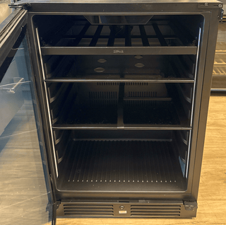 Empty black refrigerator with open door on a wooden floor